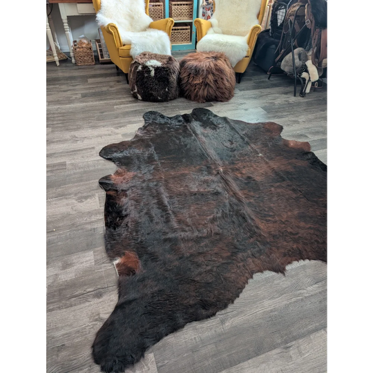 Large cowhide rug cow4 with rich dark brown black and reddish fur showcasing unique beautiful rugs characteristics