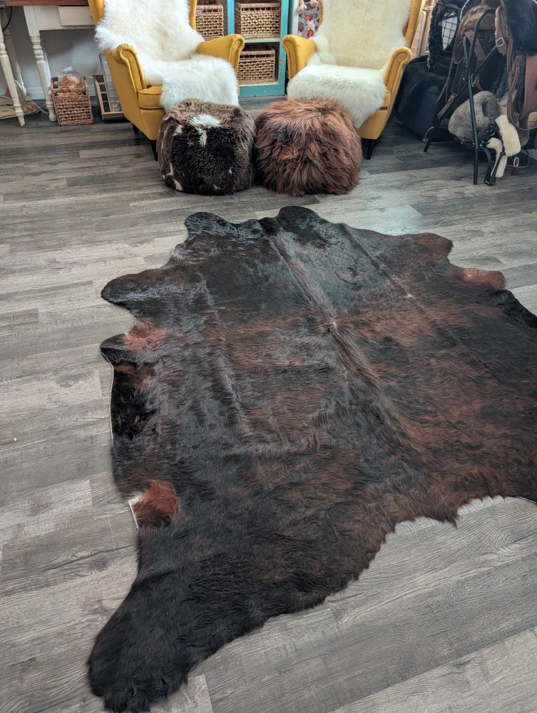 Large cowhide rug cow4 with rich dark brown black and reddish fur showcasing unique beautiful rugs characteristics