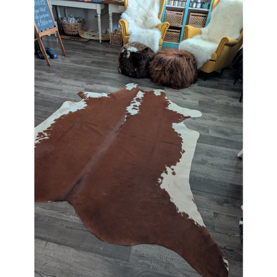 Large cowhide rug in brown and white with unique natural patterns perfect for beautiful rugs and home decor