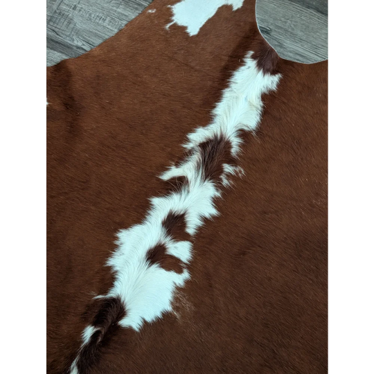 Large cowhide rug cow5 with brown and white natural fur texture showcasing unique characteristics and beautiful rugs