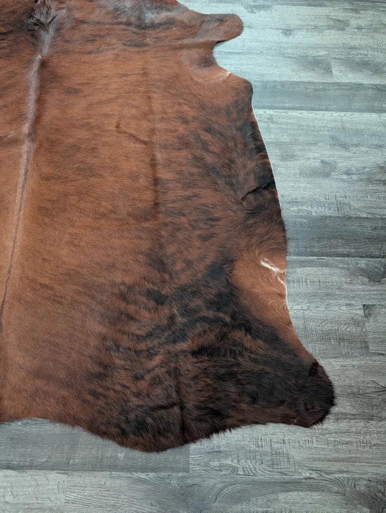 Large cowhide rug cow6 with natural brown and black fur texture showcasing unique characteristics and beautiful rugs