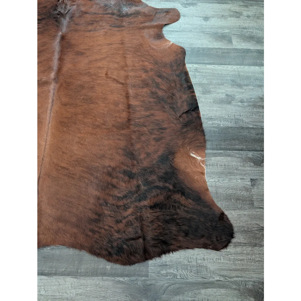 Large cowhide rug cow6 with natural brown and black fur texture showcasing unique characteristics and beautiful rugs