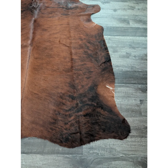 Large cowhide rug cow6 with natural brown and black fur texture showcasing unique characteristics and beautiful rugs