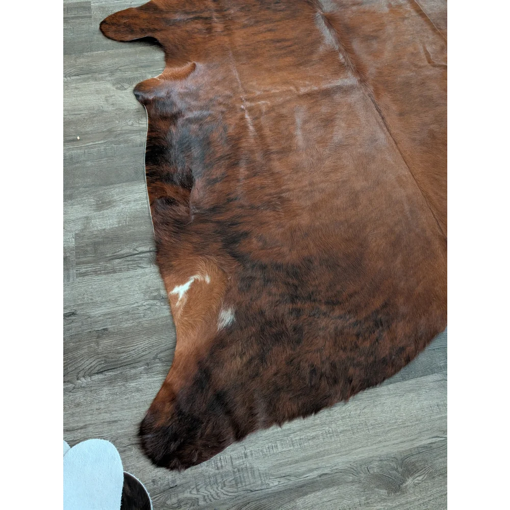 Brown large cowhide rug with natural fur texture and irregular dark patches perfect for unique beautiful rugs