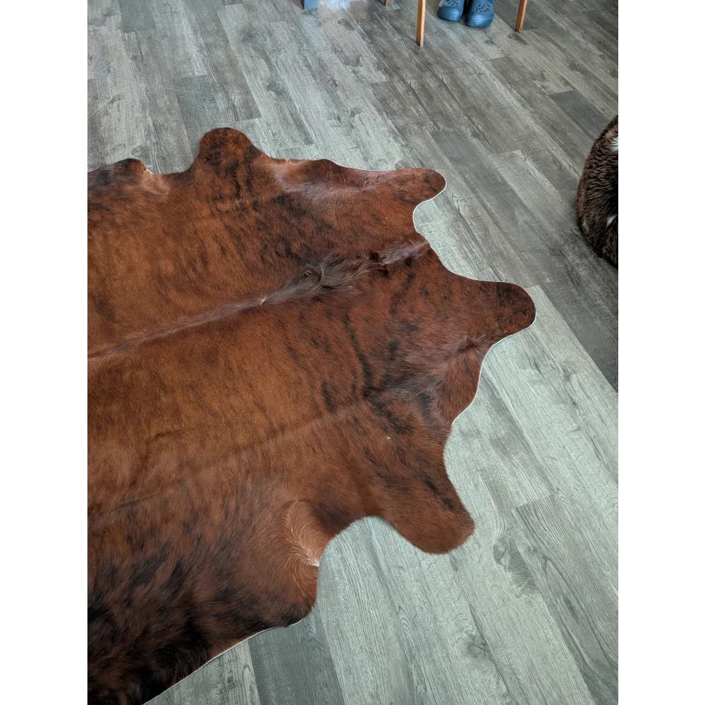 Brown large cowhide rug with natural fur texture and irregular edges perfect for beautiful rugs with unique characteristics