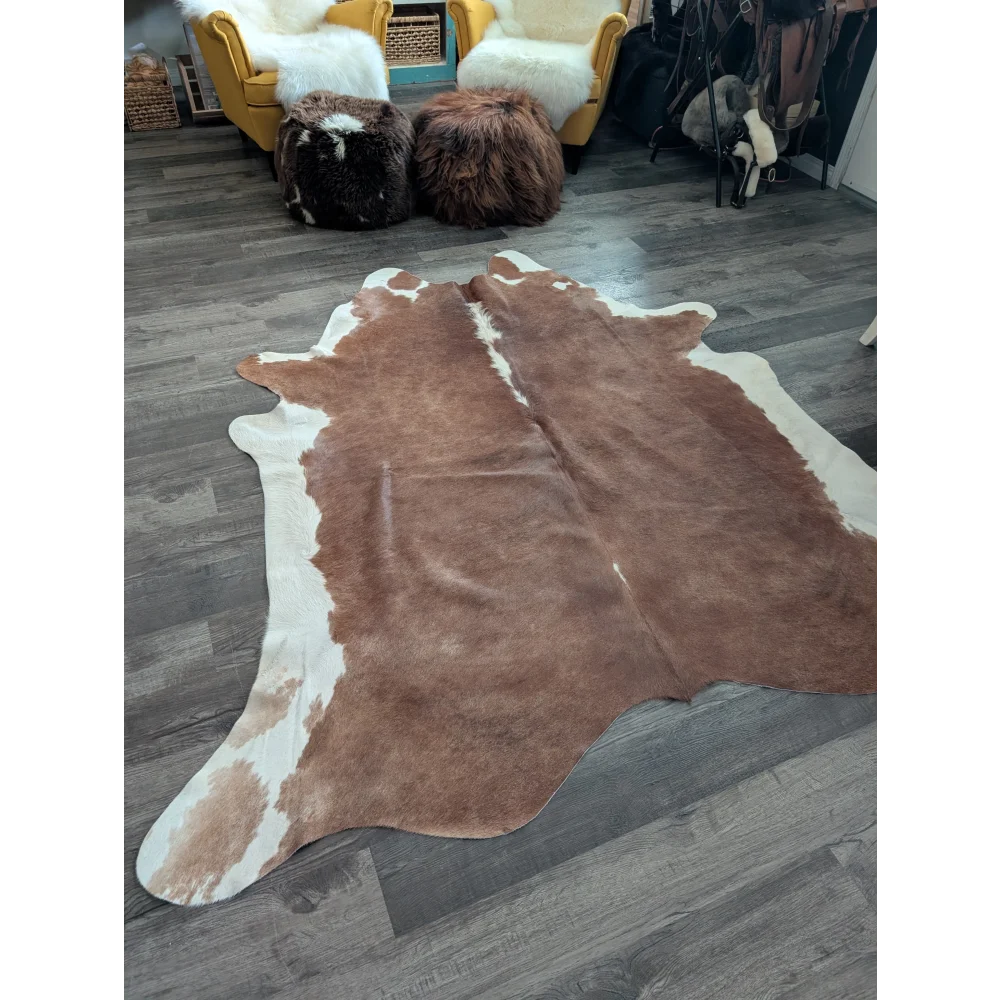Large cowhide cow7 rug with brown and white natural fur texture featuring unique characteristics and beautiful rugs style