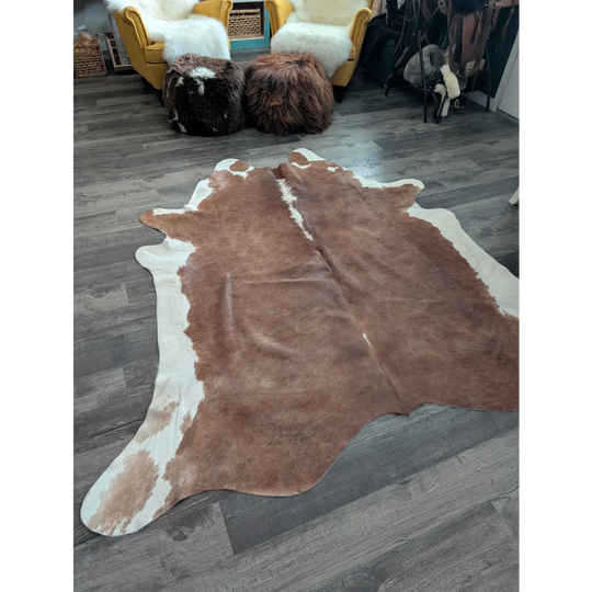 Large cowhide cow7 rug with brown and white natural fur texture featuring unique characteristics and beautiful rugs style