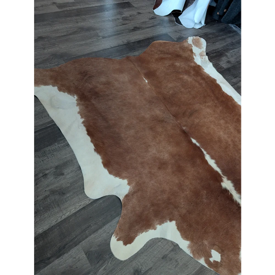 Large cowhide brown and white rug with natural fur texture showcasing beautiful rugs and unique characteristics