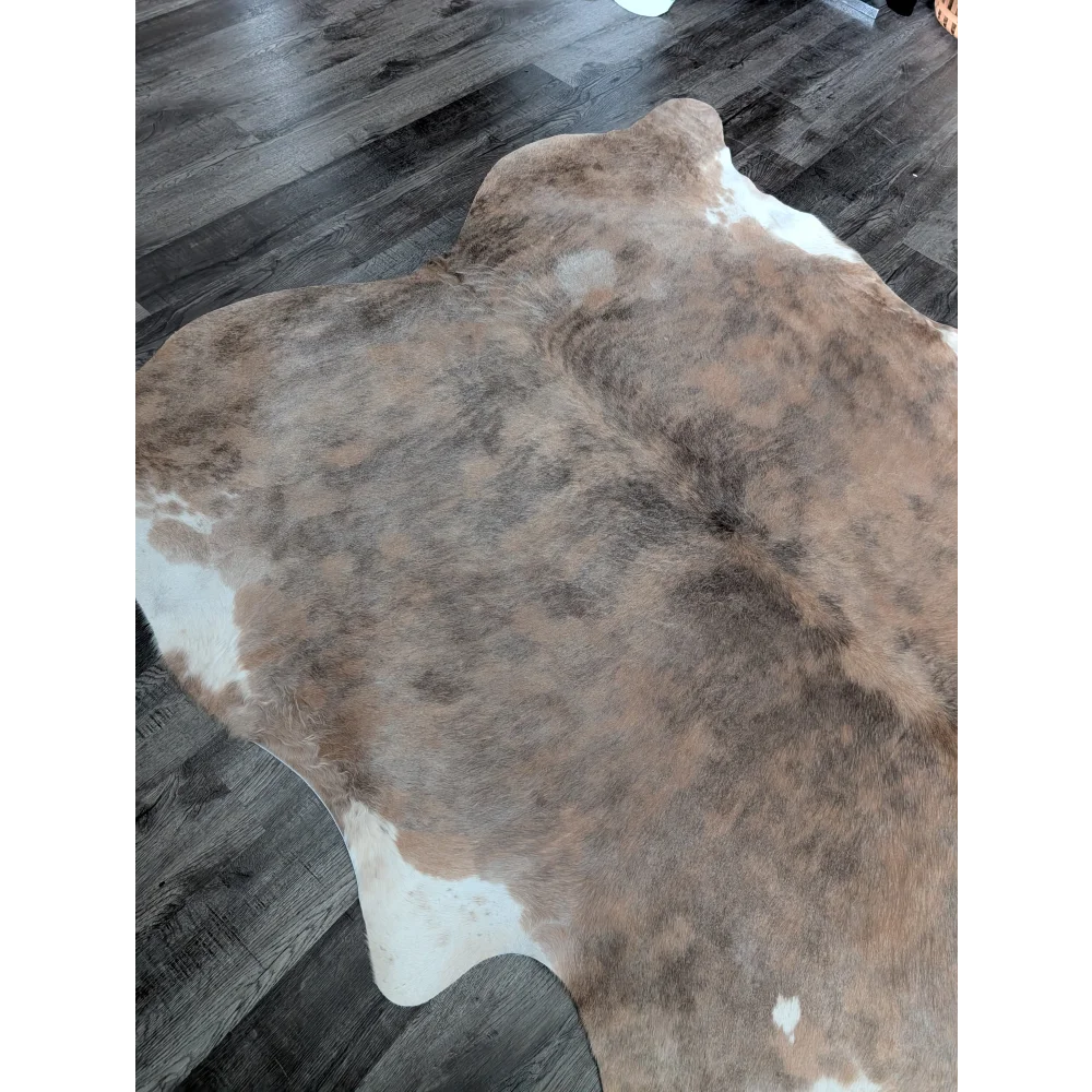 Brown and white large cowhide rug with natural fur texture showcasing unique characteristics for beautiful rugs