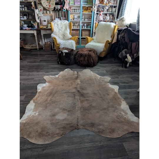 Large cowhide rug in natural brown and white with soft texture showcasing unique characteristics for beautiful rugs