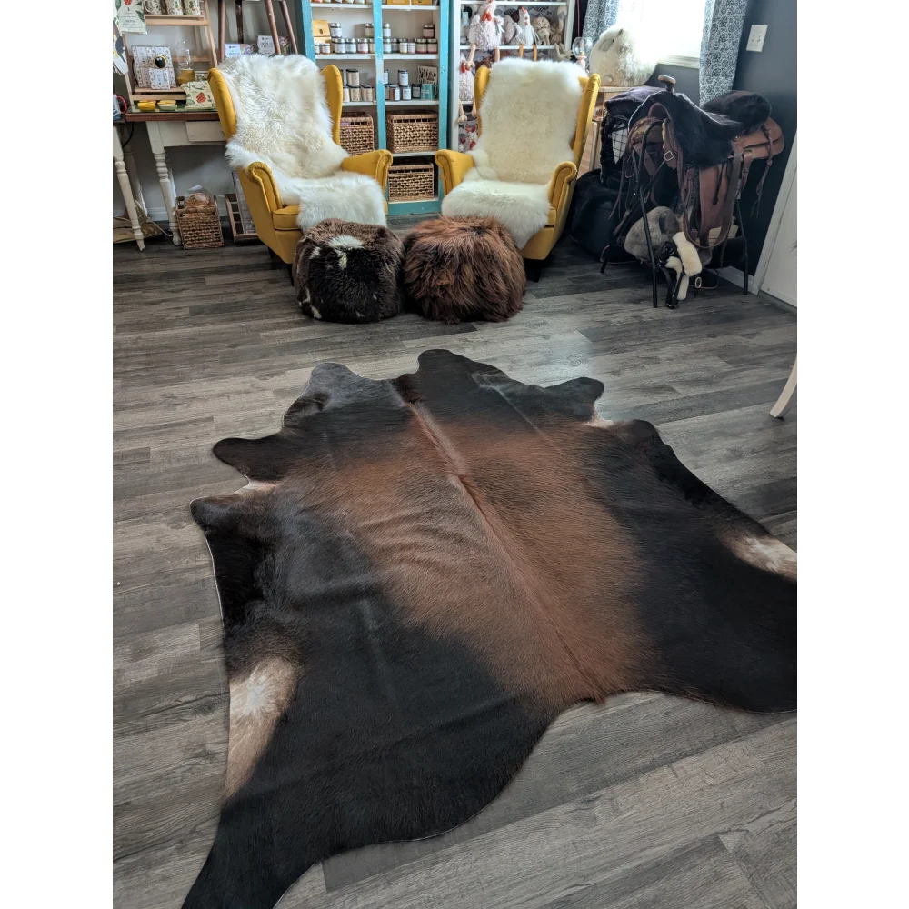 Large cowhide rug with beautiful brown and black natural fur texture showcasing unique characteristics