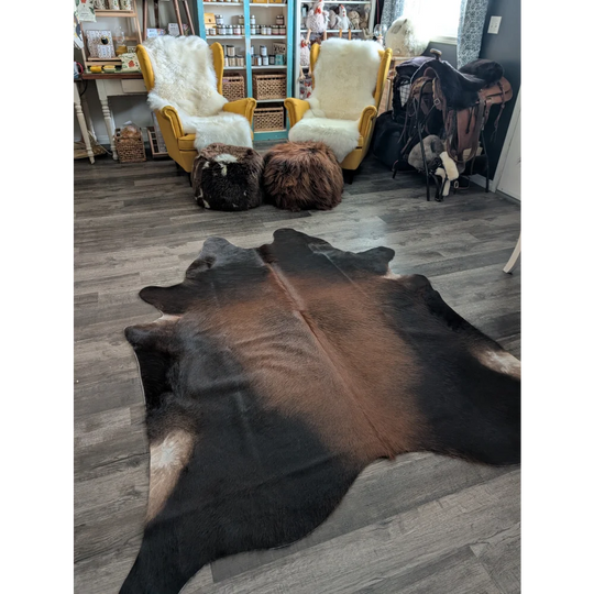 Large cowhide rug with beautiful brown and black natural fur texture showcasing unique characteristics