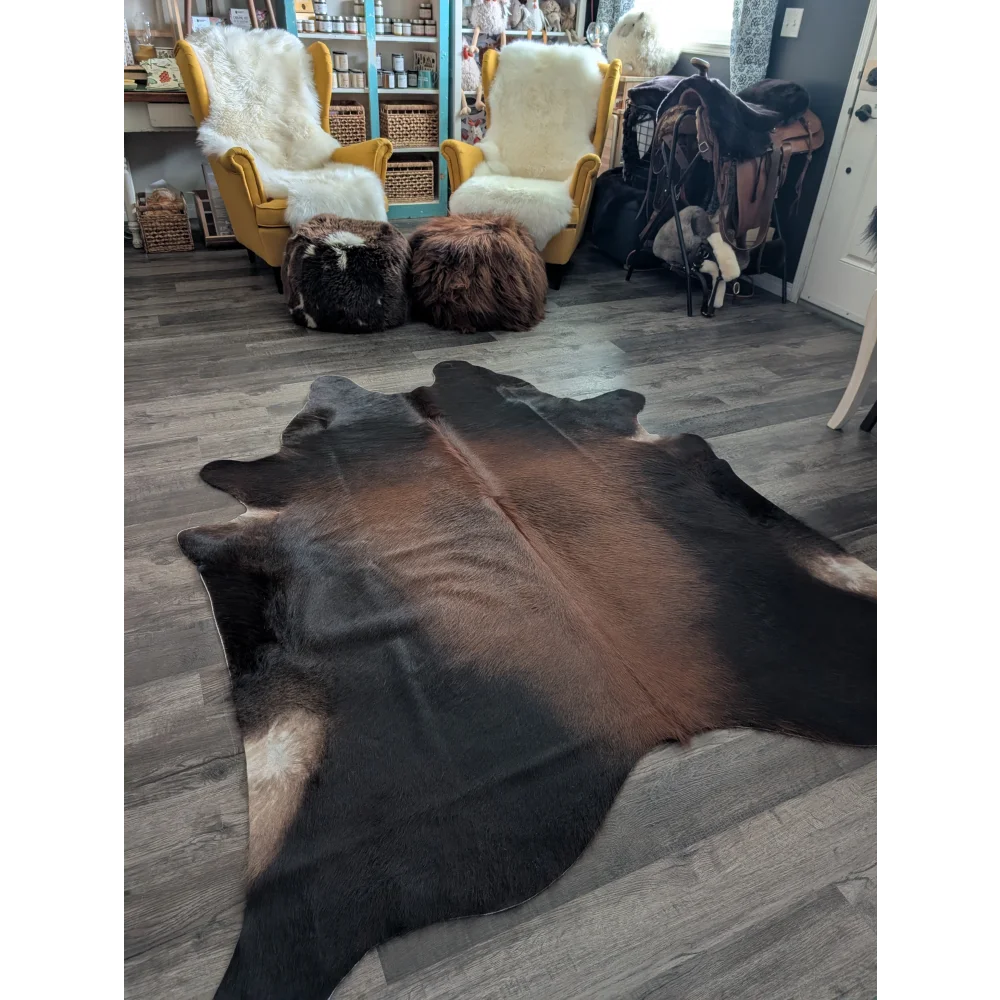 Large cowhide rug with brown and black natural fur texture showcasing unique characteristics in beautiful rugs