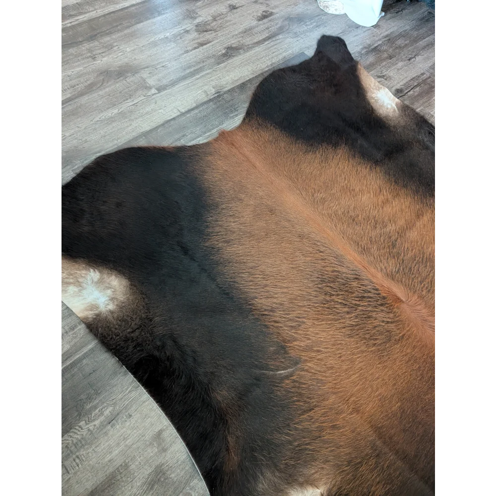 Large cowhide rug with brown and black natural fur texture showcasing beautiful rugs and unique characteristics