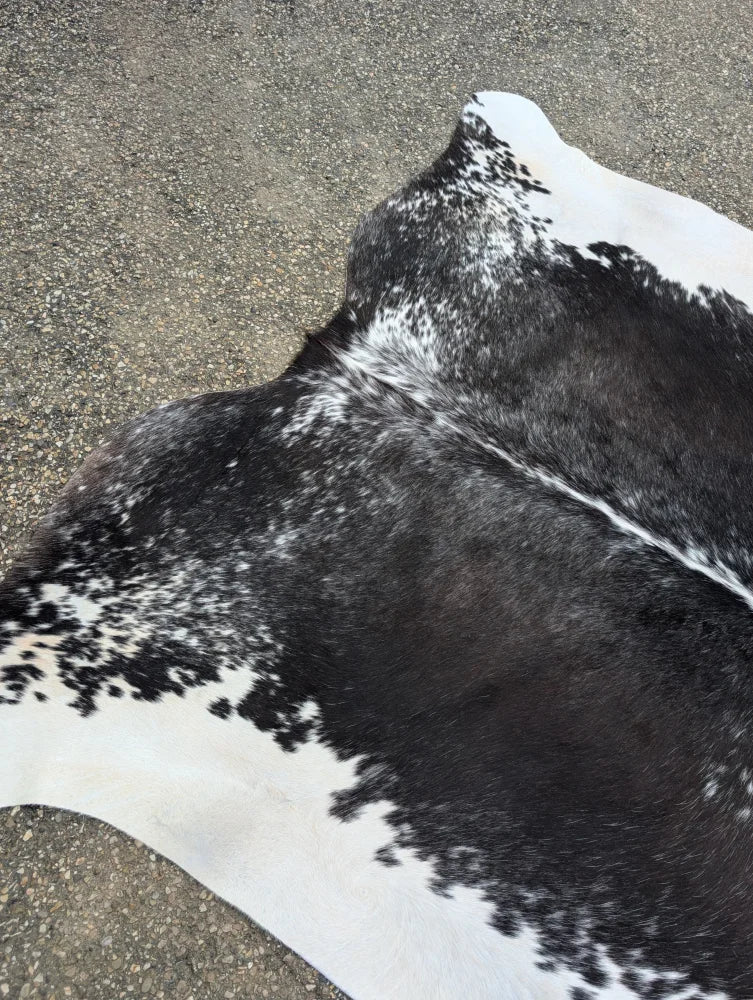 Large black and white cowhide rug with natural fur texture showcasing beautiful rugs and unique characteristics