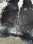 Large cowhide rug with black and white natural fur texture featuring unique characteristics for beautiful rugs