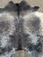 Extra large black and white speckled cowhide rug with natural texture showcasing unique characteristics and beautiful rugs design