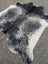 Extra large black and white speckled cowhide rug with natural edges showcasing unique characteristics for beautiful rugs
