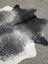 Extra large black and white cowhide rug with natural irregular edge showcasing unique characteristics and beautiful rugs style