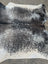 Extra large black and white cowhide rug with a beautiful speckled pattern showcasing unique characteristics