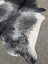 Extra large black and white speckled cowhide rug with natural edges showcasing unique characteristics for beautiful rugs