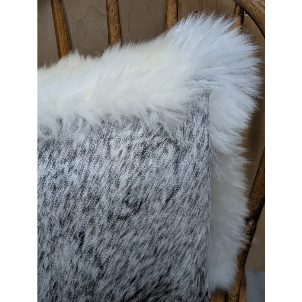 A cozy gray and white merino sheepskin cushion with plush faux fur texture by angus oliver canada
