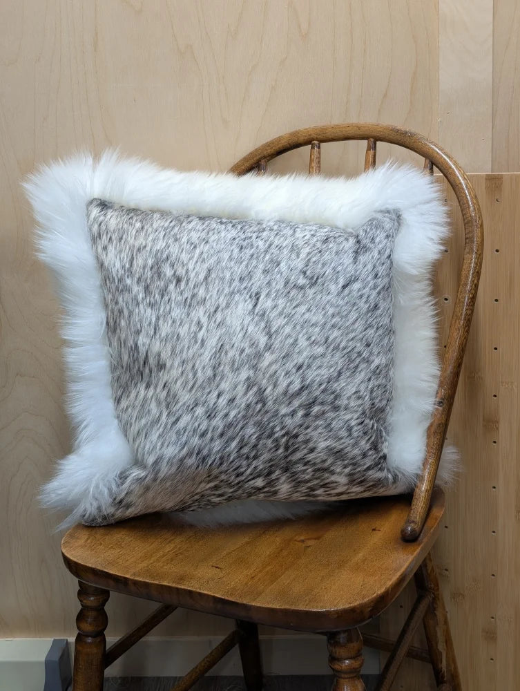 Gray and white speckled cowhide pillow with plush white merino sheepskin trim by angus oliver canada