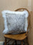 Gray and white speckled cowhide pillow with plush white merino sheepskin trim by angus oliver canada