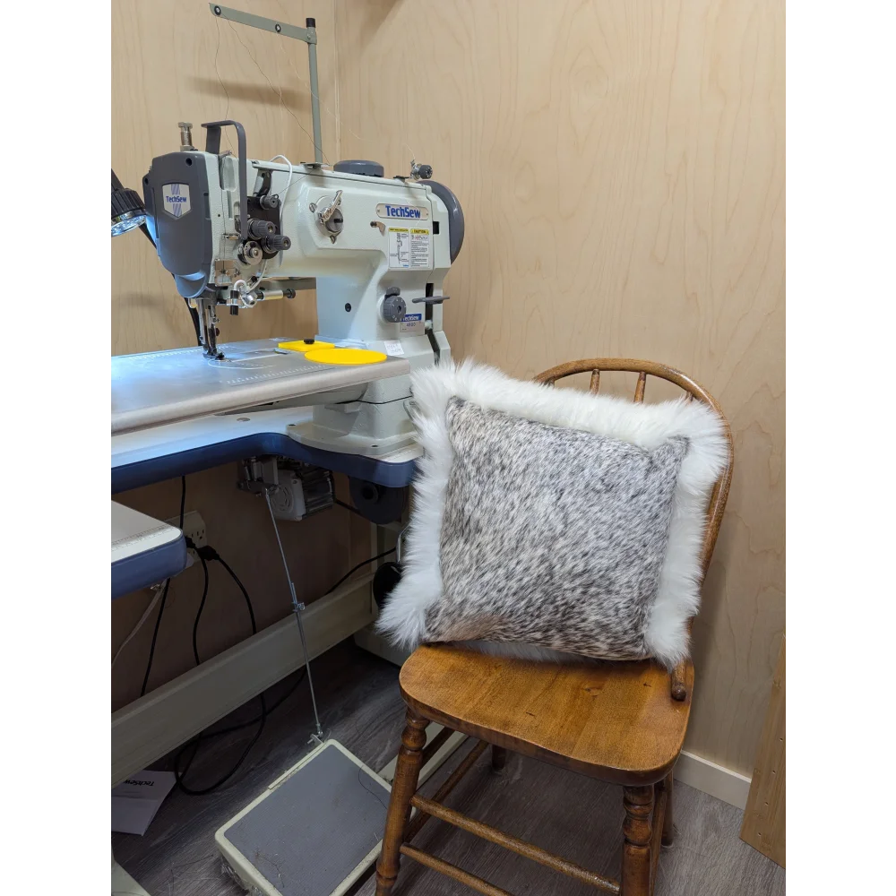 Gray and white merino sheepskin throw pillow with fluffy textured surface by angus oliver from canada