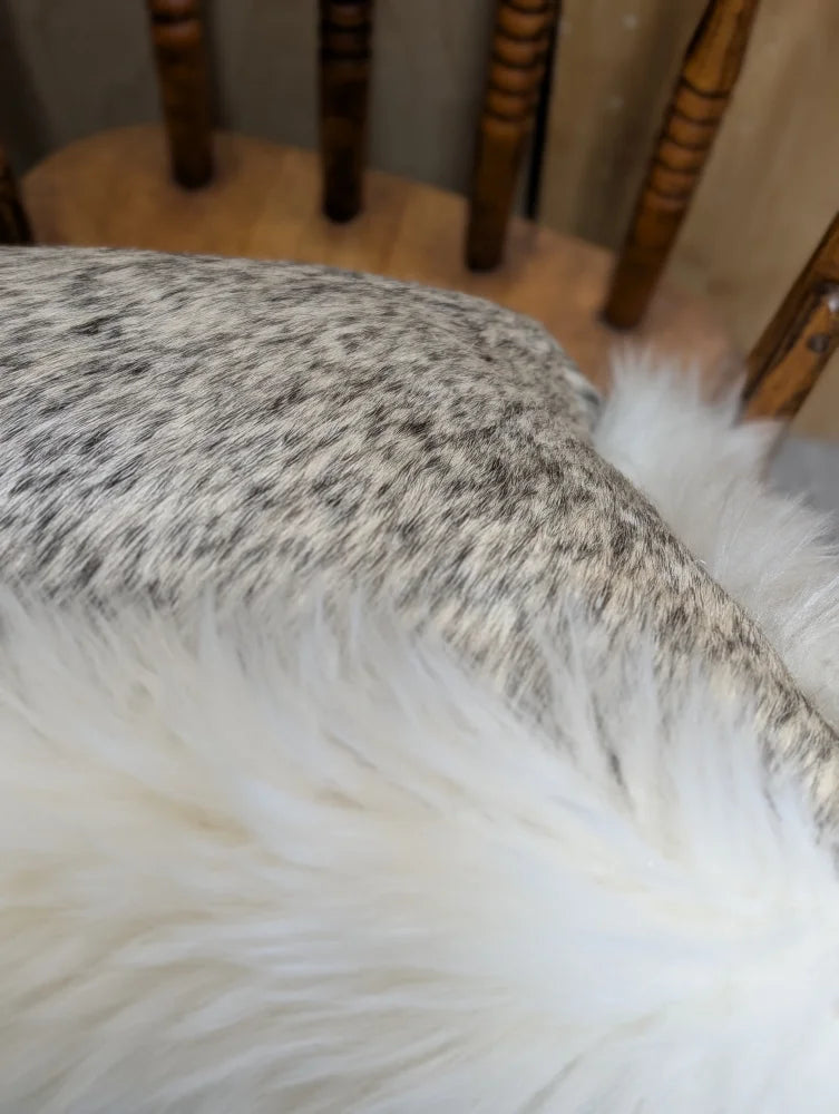 A plush white faux fur throw blanket with soft fluffy texture made from merino sheepskin by angus oliver canada