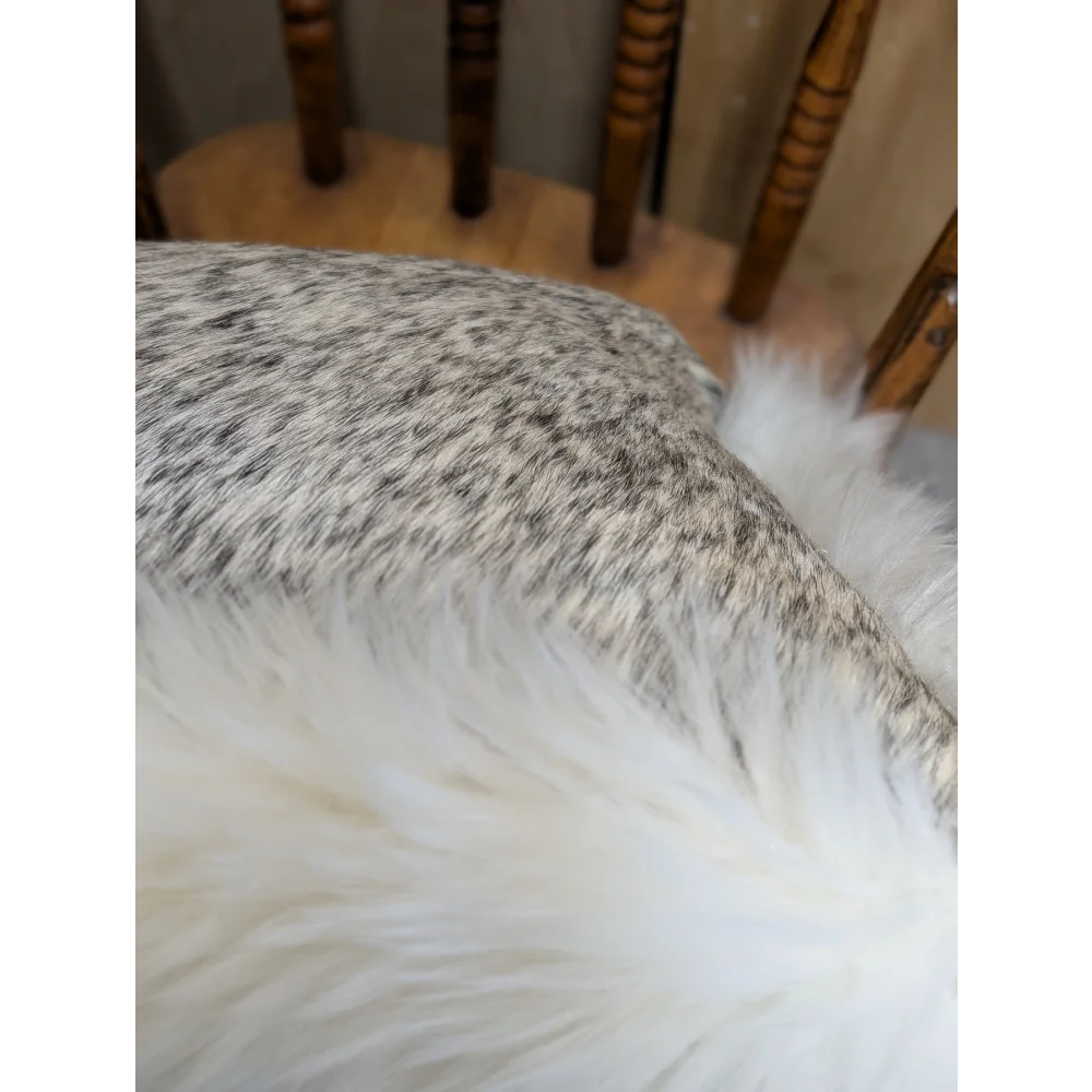 A plush white faux fur throw blanket with soft fluffy texture made from merino sheepskin by angus oliver canada