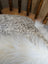 A plush white faux fur throw blanket with soft fluffy texture made from merino sheepskin by angus oliver canada