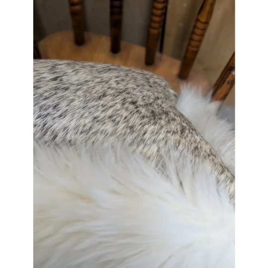 A plush white faux fur throw blanket with soft fluffy texture made from merino sheepskin by angus oliver canada