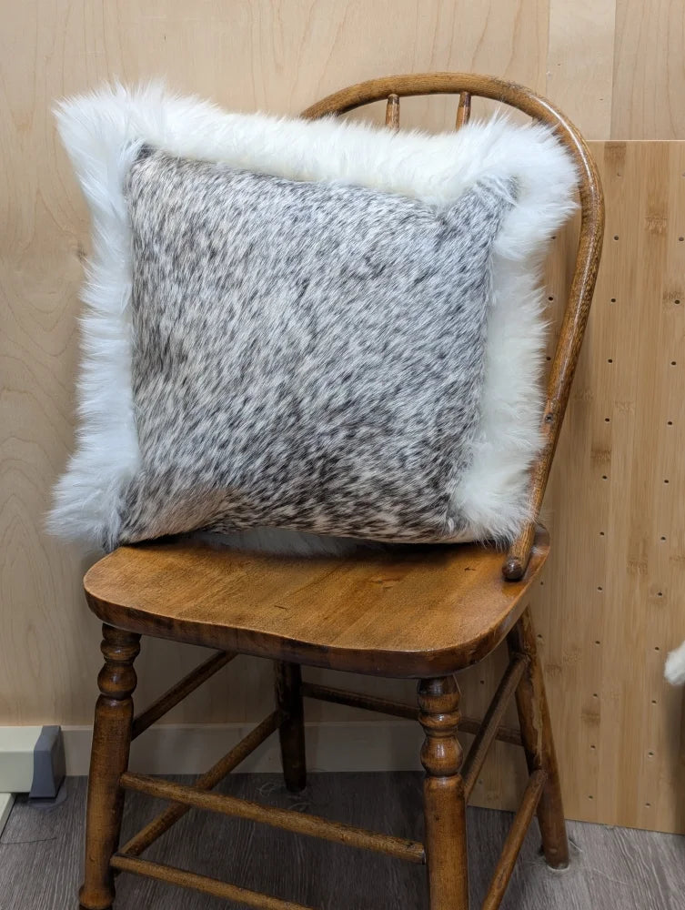 Gray and white speckled cowhide pillow with plush white merino sheepskin trim by angus oliver canada