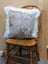 Gray and white speckled cowhide pillow with plush white merino sheepskin trim by angus oliver canada