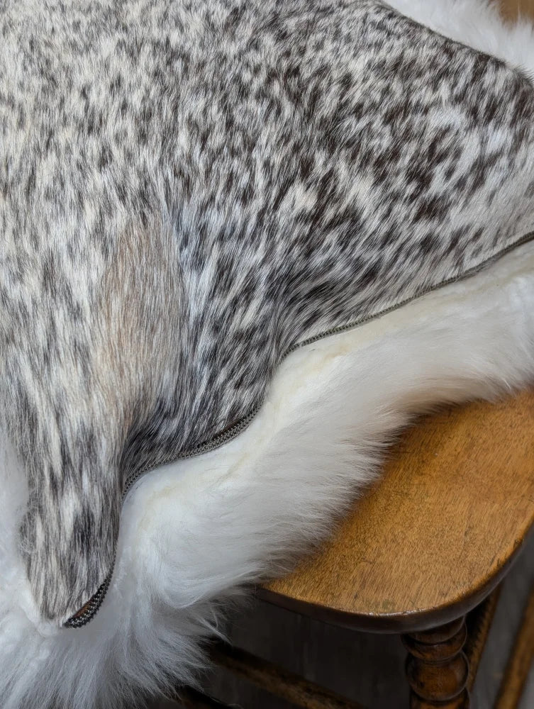 A plush gray and white speckled faux fur throw with soft fluffy texture from angus oliver merino sheepskin canada