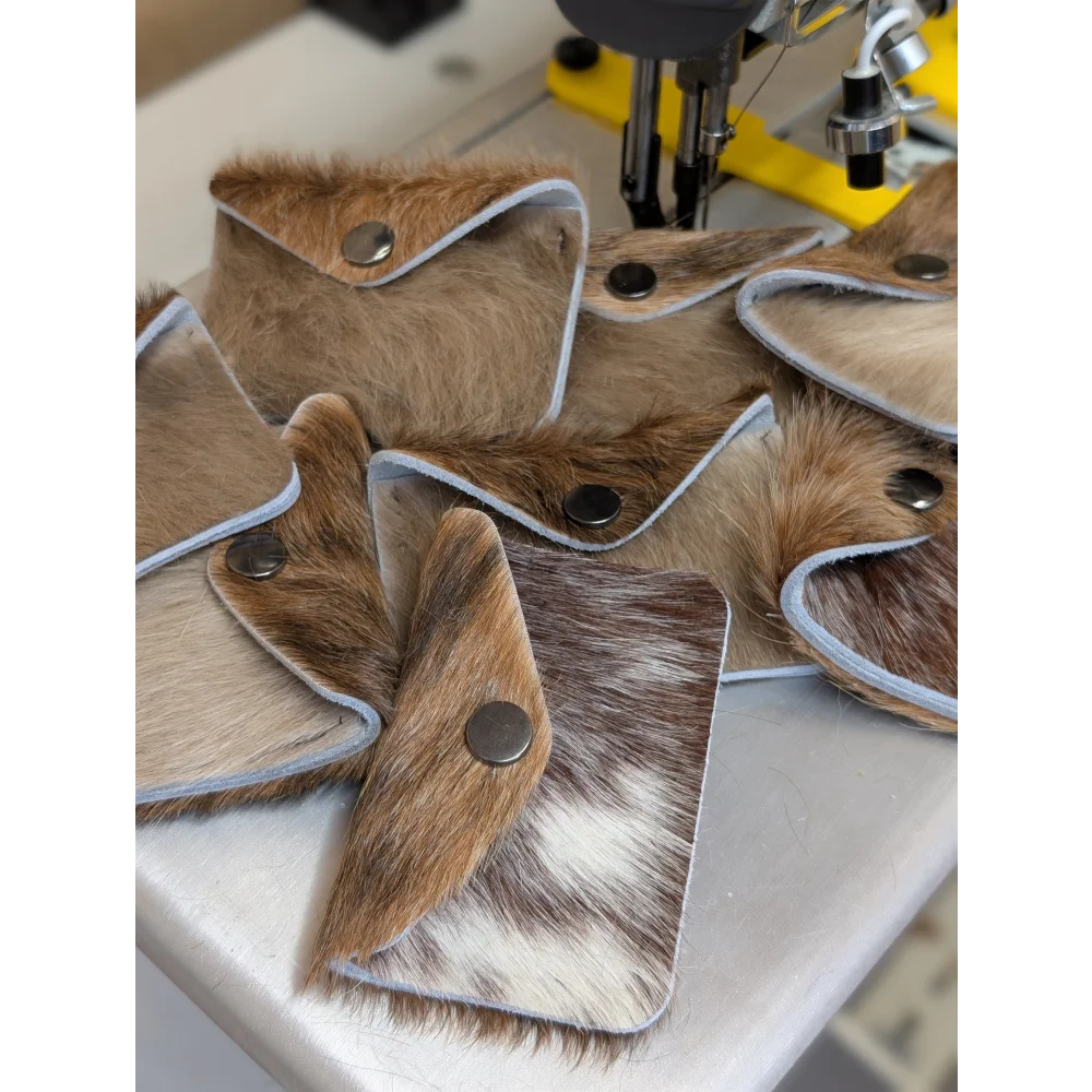 Brown and white cowhide wallet with silver snap closure perfect for angus oliver fans who love canada cowhide rugs