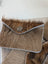 Brown fur cowhide bank card holder with silver button closure and light gray stitch trim by angus oliver canada