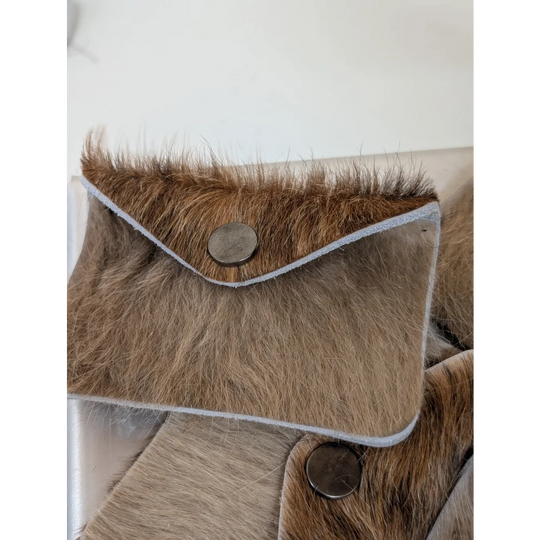 Brown fur cowhide bank card holder with silver button closure and light gray stitch trim by angus oliver canada