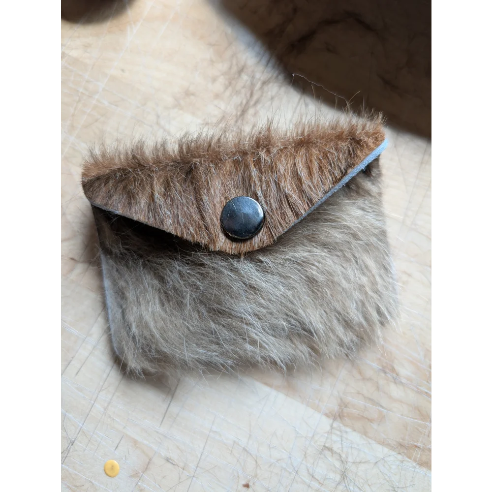 Furry brown and gray cowhide bank card holder with black button closure by angus oliver canada sheepskin rugs and cowhide rugs