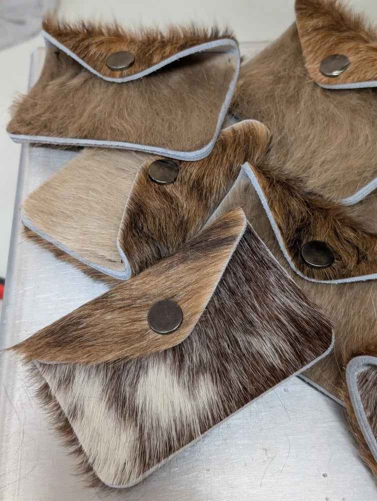 Brown and white cowhide bank card holder with silver snap button closure by angus oliver canada for sheepskin rugs fans