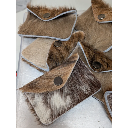 Brown and white cowhide bank card holder with silver snap button closure by angus oliver canada for sheepskin rugs fans