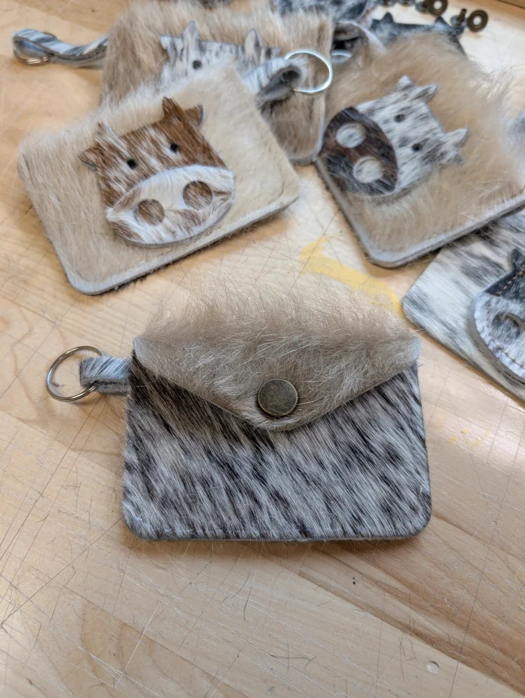 Gray and white cowhide keychain card holder pouch with stitched flap metal button closure and attached ring