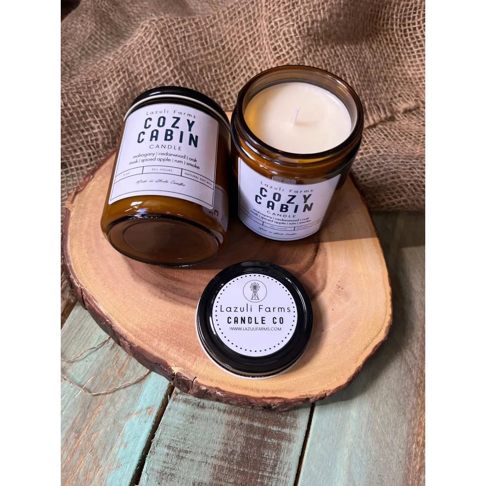 Cozy Cabin Candle in amber jar with white label, Lazuli Farms