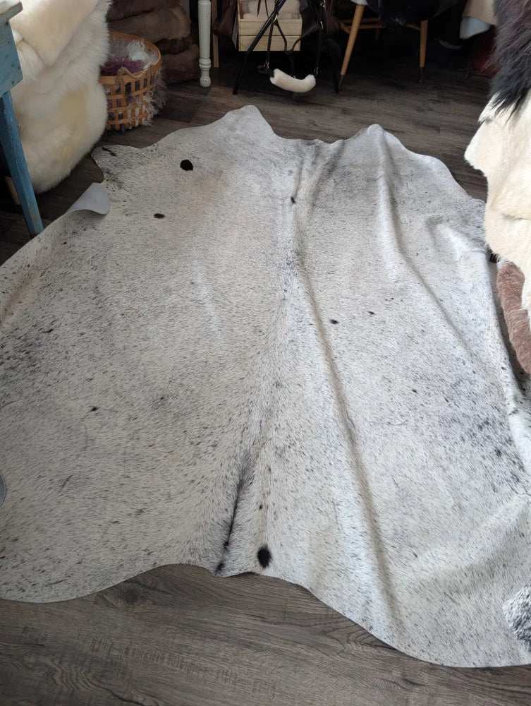 Massive 93x87 Angus Oliver cowhide rug on wood floor, Canada