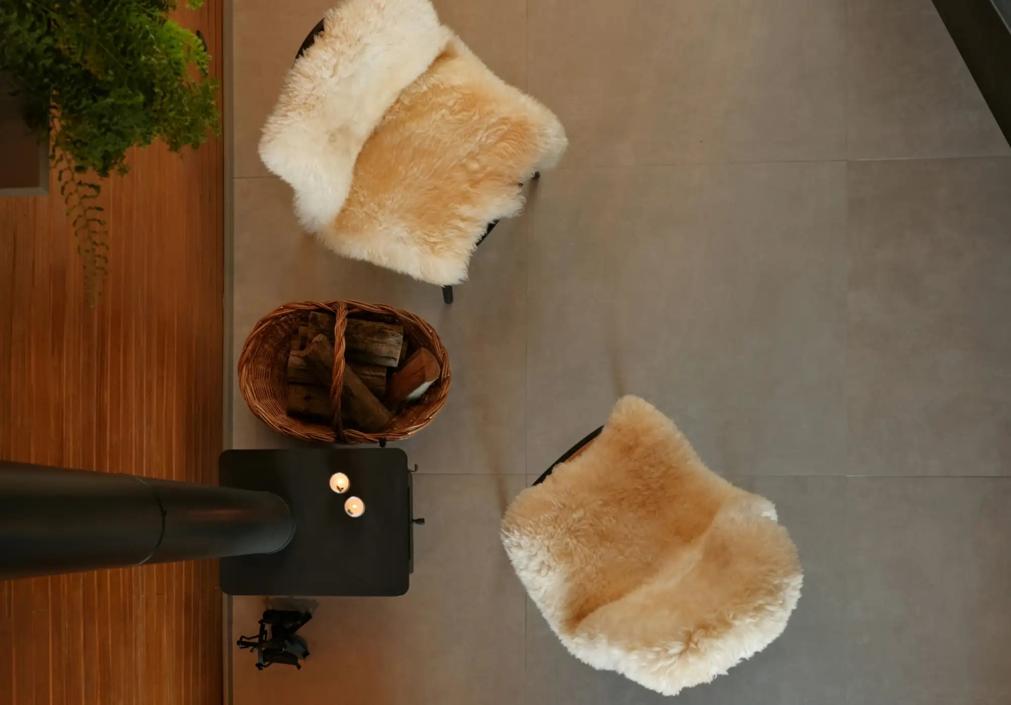 Cream-colored sheepskin throw draped over a dark wooden chair.