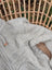 A soft fleece cream woolen calgary cardigan with light gray knit texture and wooden toggle closure