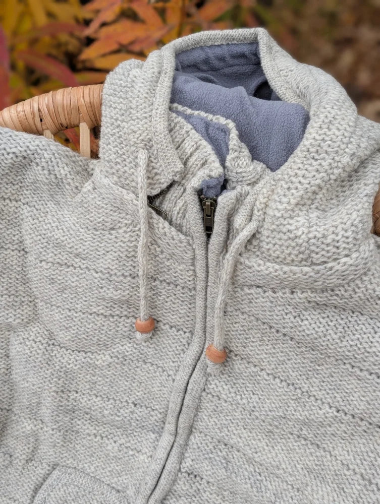 Cream woolen calgary cardigan in light gray knit with soft fleece blue lining and wooden toggle pulls made from zealand wool