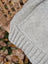 A soft fleece cream woolen calgary cardigan in heather gray with a ribbed hem and textured stitch pattern