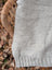 Cream woolen calgary cardigan featuring a soft fleece light gray knit with textured pattern and ribbed hem made from zealand wool